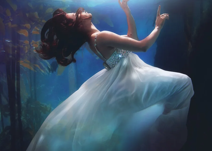 underwater photography of woman wearing white dress